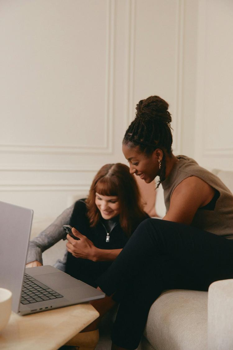 Two women looking at a laptop